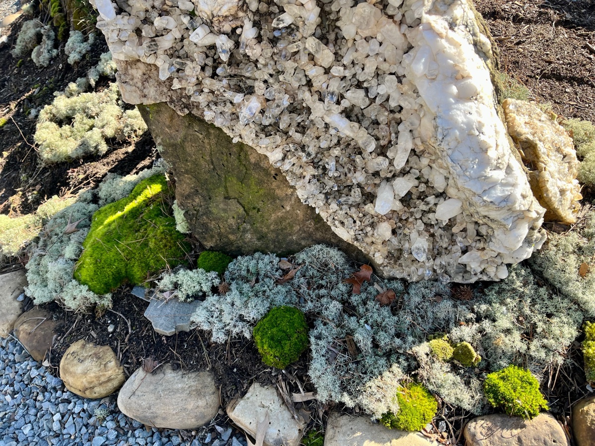Quartz crystal boulder feature set in moss