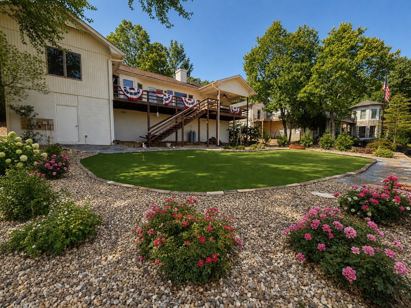 Outdoor living space with turf, stone and mature planting